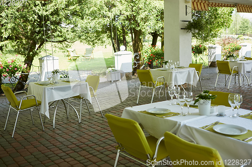 Image of terrace summer cafe with tables and chairs for people, an empty institution for recreation, nobody