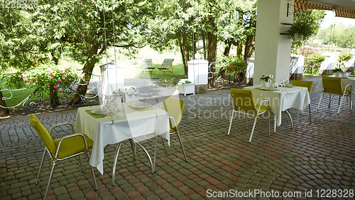 Image of terrace summer cafe with tables and chairs for people, an empty institution for recreation, nobody