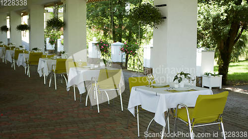 Image of terrace summer cafe with tables and chairs for people, an empty institution for recreation, nobody