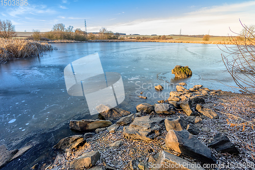 Image of rural landscape with frozen small pond