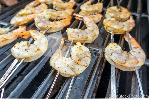 Image of jumbo shrimp on skewers on a grill for dinner