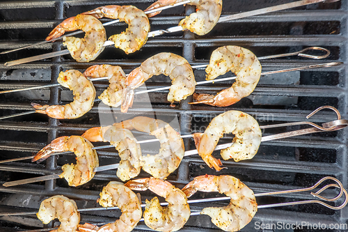 Image of jumbo shrimp on skewers on a grill for dinner
