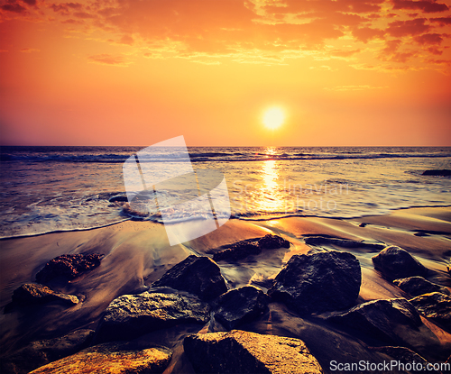 Image of Waves and rocks on beach of sunset