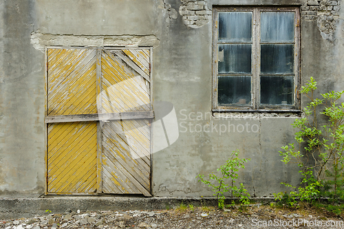 Image of old brick wall with door and window