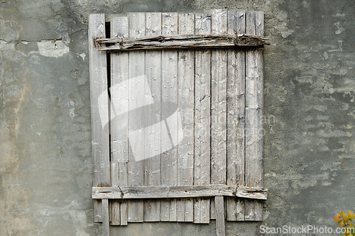 Image of old window covered with gray wood