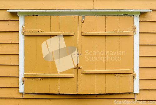 Image of old window shutter with white moldings