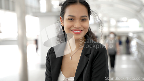 Image of Portrait of asian businesswoman standing outside of office building