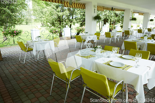 Image of terrace summer cafe with tables and chairs for people, an empty institution for recreation, nobody