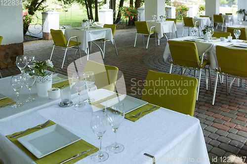 Image of terrace summer cafe with tables and chairs for people, an empty institution for recreation, nobody