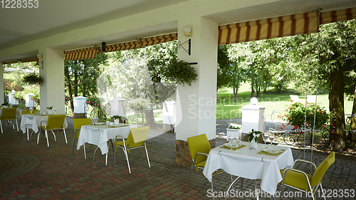 Image of terrace summer cafe with tables and chairs for people, an empty institution for recreation, nobody