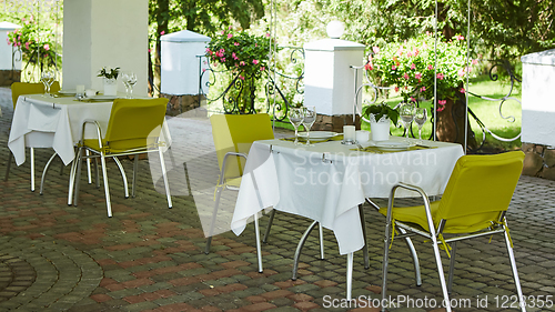 Image of terrace summer cafe with tables and chairs for people, an empty institution for recreation, nobody