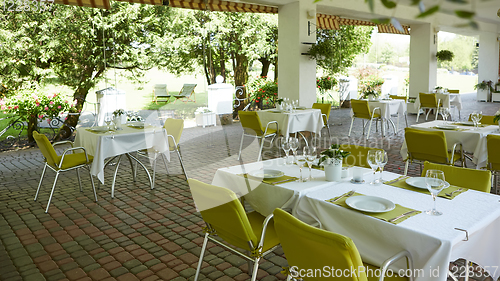 Image of terrace summer cafe with tables and chairs for people, an empty institution for recreation, nobody