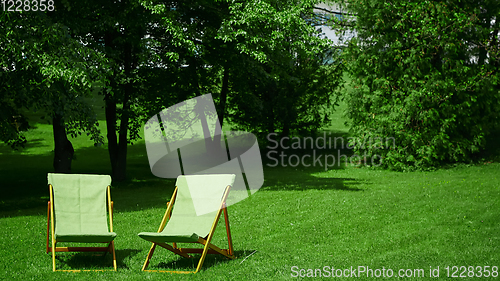 Image of Two resting chairs in the city park