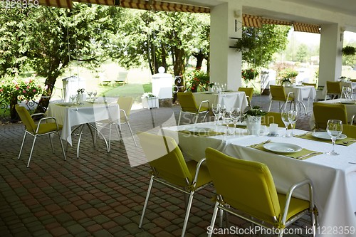 Image of terrace summer cafe with tables and chairs for people, an empty institution for recreation, nobody