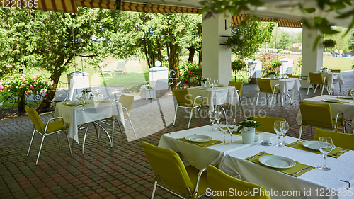 Image of terrace summer cafe with tables and chairs for people, an empty institution for recreation, nobody