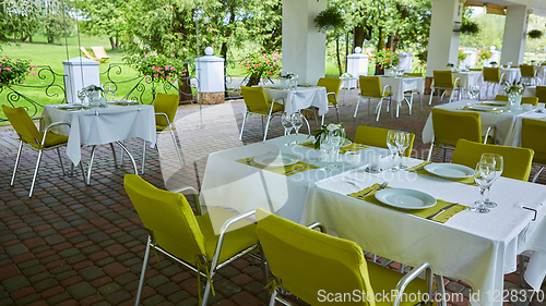 Image of terrace summer cafe with tables and chairs for people, an empty institution for recreation, nobody