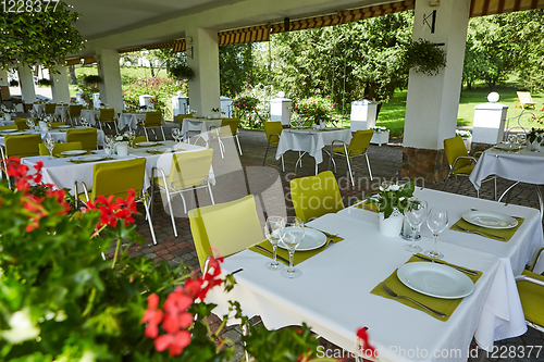 Image of terrace summer cafe with tables and chairs for people, an empty institution for recreation, nobody