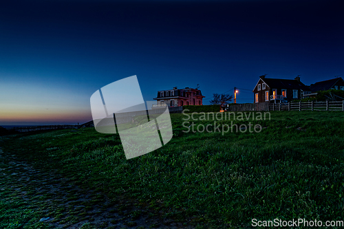 Image of Houses on a picturesque hill overlooking the ocean. beautiful night scenery