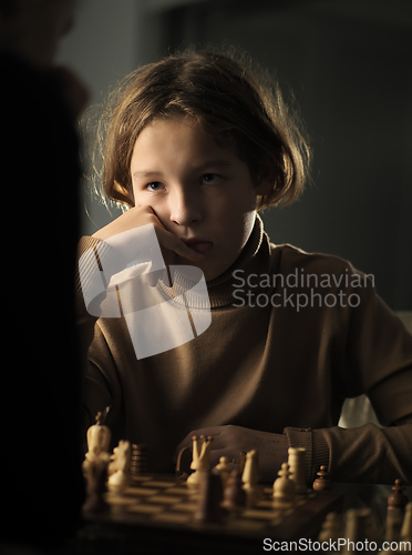 Image of The teenager made a move while playing chess