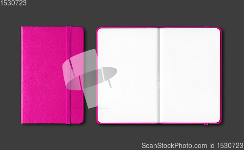 Image of Pink closed and open notebooks isolated on black