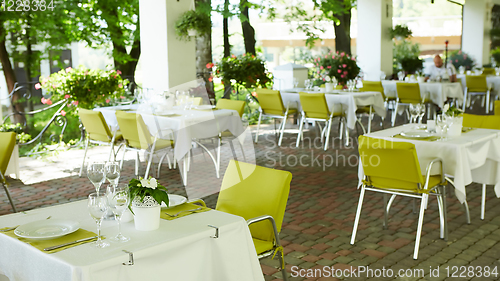 Image of terrace summer cafe with tables and chairs for people, an empty institution for recreation, nobody