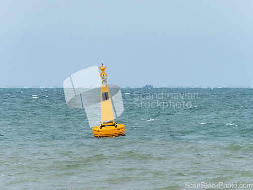 Image of Yellow buoy at sea to mark a danger area