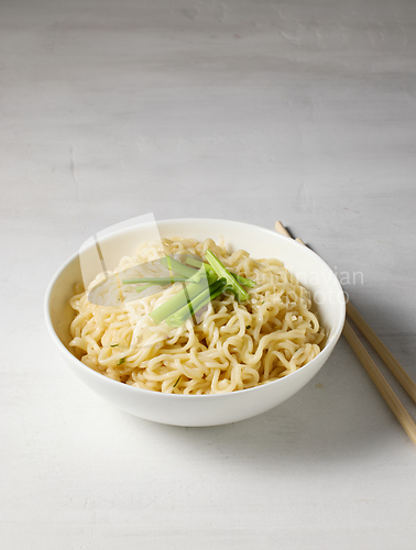 Image of bowl of boiled noodles and chopsticks