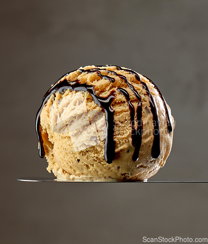 Image of caramel ice cream scoop with chocolate sauce