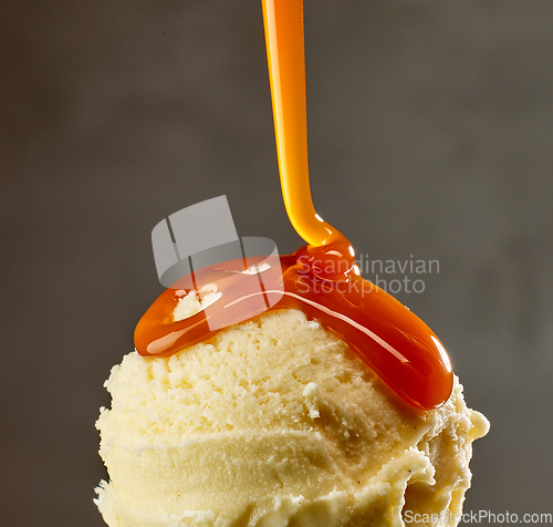 Image of caramel sauce flowing on vanilla ice cream