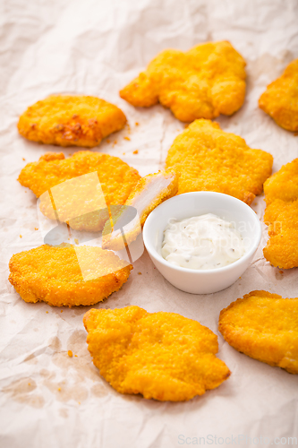 Image of Small chicken schnitzel on baking sheet with herb mayonnaise 