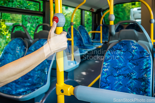 Image of Interior of a city bus. Empty bus interior. Bus with blue seats and yellow handrails