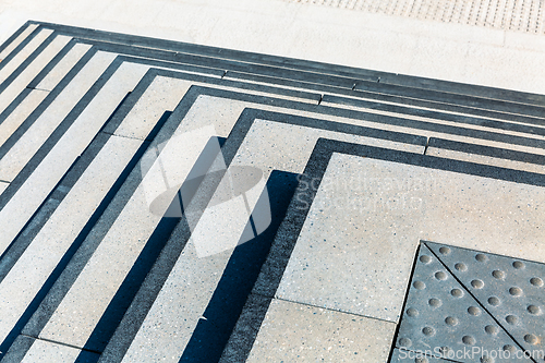 Image of Sunlight and shadow on wide stone staircase. Abstract theme.