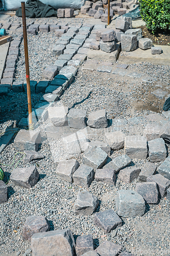 Image of Making path - paving stones, installing and laying pavement stones on terrace, road or sidewalk