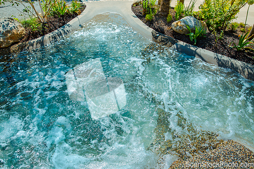 Image of Natural swimming pond or natural spa jacuzzi for a small garden