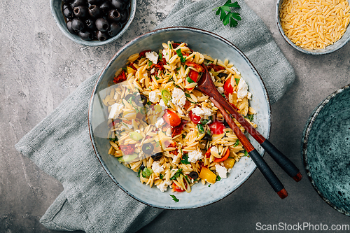 Image of Homemade orzo pasta salad with feta, olives, tomatoes