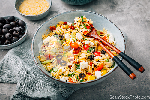 Image of Homemade orzo pasta salad with feta, olives, tomatoes