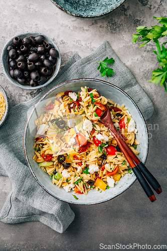 Image of Homemade orzo pasta salad with feta, olives, tomatoes