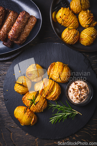 Image of Hasselback potatoes with additional herbs, spices and whipped feta dip