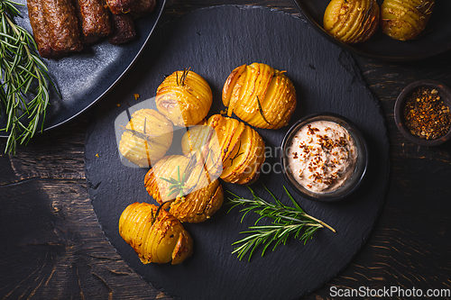 Image of Hasselback potatoes with additional herbs, spices and whipped feta dip