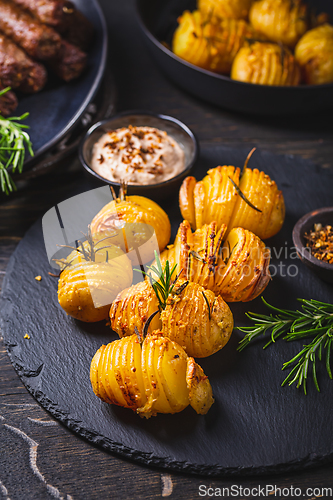 Image of Hasselback potatoes with additional herbs, spices and whipped feta dip