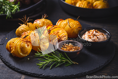 Image of Hasselback potatoes with additional herbs, spices and whipped feta dip