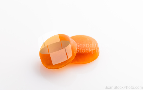 Image of Two sugar-free honey cough drop with herbs on white background