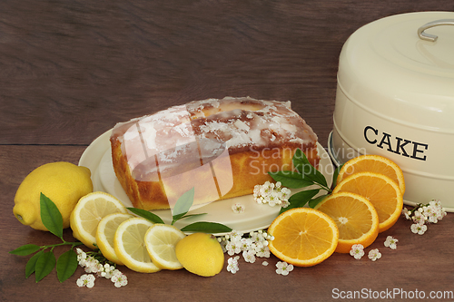 Image of Lemon and Orange Drizzle Cake with Fruit and Blossom Flowers