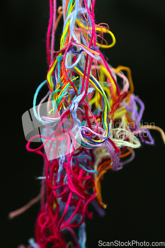 Image of Multicolored tangled threads for needlework on black background