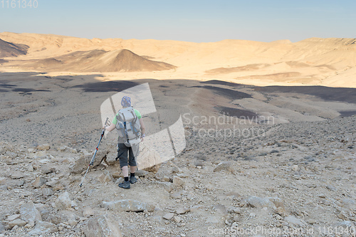 Image of Hiking tourist in desert trek adventure