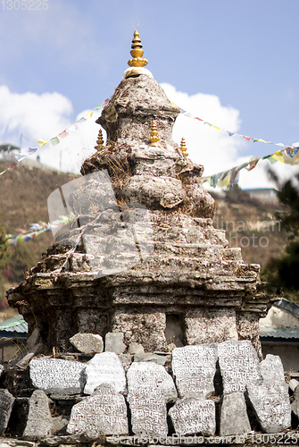 Image of Buddhism stupa or chorten with prayer flags in Himalayas