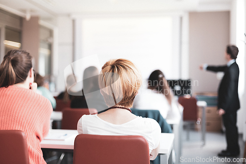 Image of Speaker Giving a Talk at Business Meeting. Audience in the conference hall. Business and Entrepreneurship. Copy space on white board