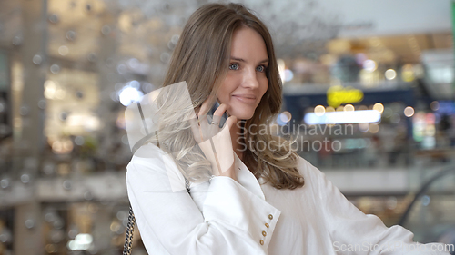 Image of Elegant Young Woman Enjoying Wireless Chat in the City Mall