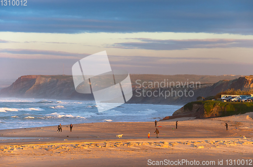 Image of People walking ocean beach Portugal