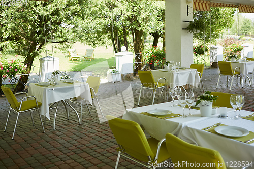 Image of terrace summer cafe with tables and chairs for people, an empty institution for recreation, nobody